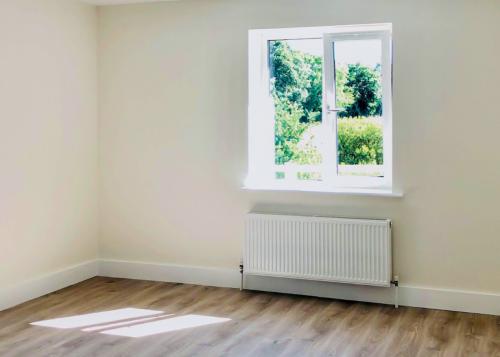 New radiators fitted beneath window