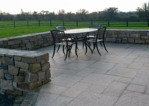 patio area with stone wall in countryside