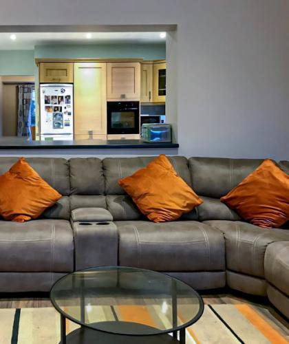 living area with window opening to kitchen space