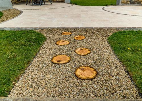 Log style stepping stones surrounded by loose stone