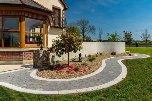 Small tree and walkway by Castle Masons